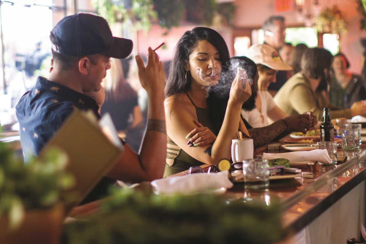couple smokes marijuana at original cannabis cafe