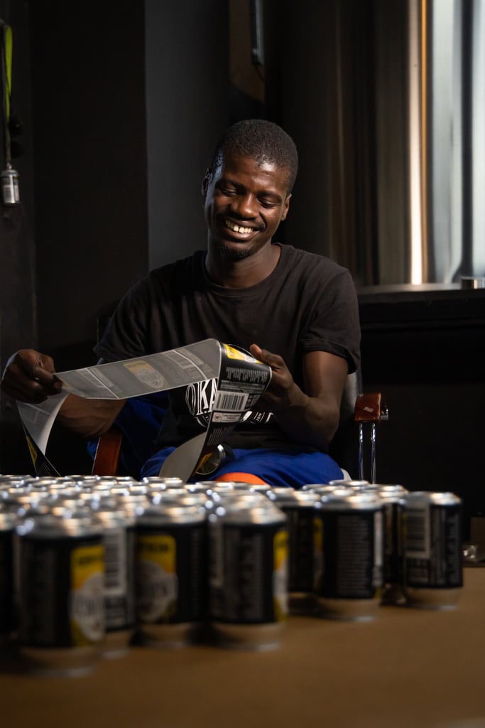 Okavango craft brewery worker wraps cans in the brewhouse