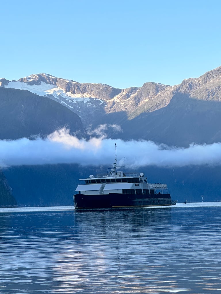 cascadia ship maple leaf adventures with heavy fog above and towering mountains behind