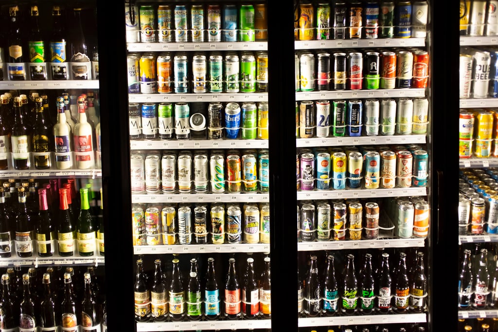 A cooler with many different beer brands.