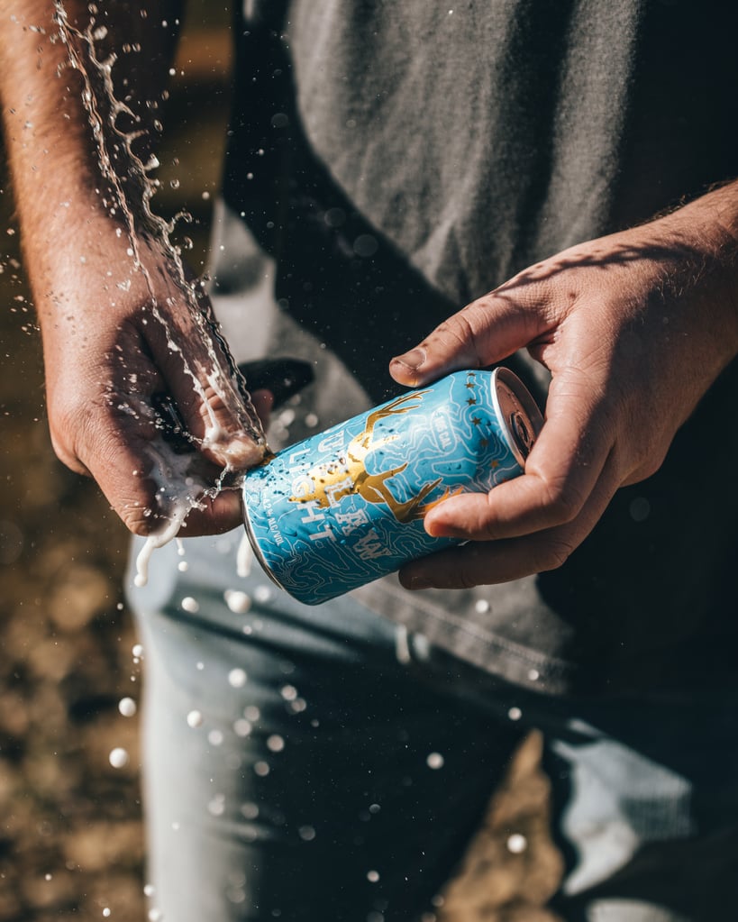 Can of outlaw light beer being cracked open