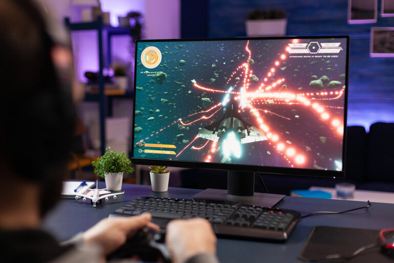Person playing an action game on a monitor, representing a Zenless Zone Zero Version 2.8 review featuring Season 2’s standout patch.