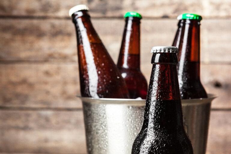 Bottles of craft beer in a flask arrangement, representing the rise of craft beer culture in 2026.